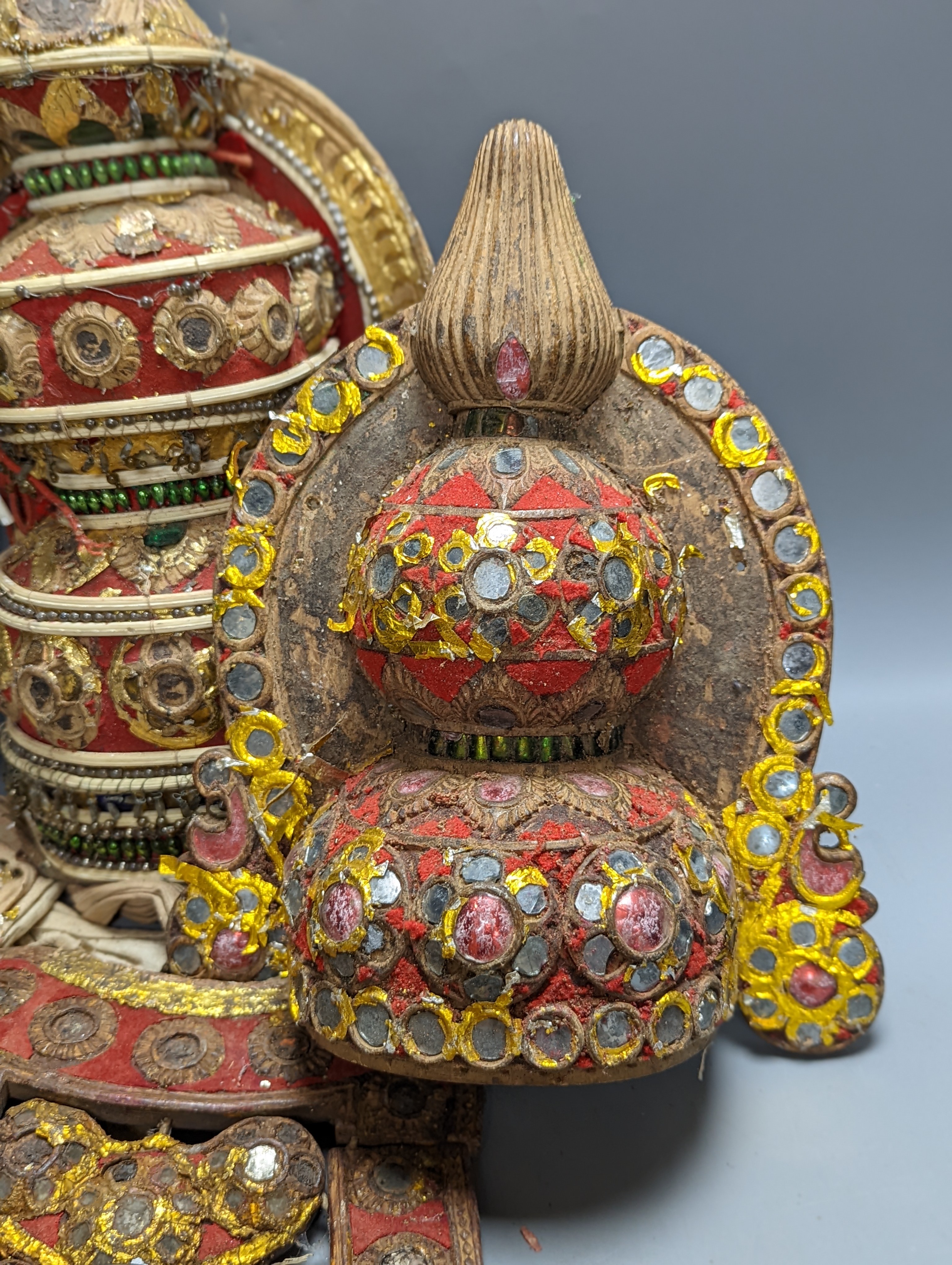 A group of Indian ornate wooden headdresses, masks etc